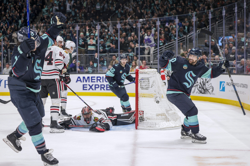 Seattle Kraken left wing Tomas Tatar, right, celebrates  a goal by left wing Brandon Tanev, left, on Chicago Blackhawks goaltender Arvid Soderblom during the second period of an NHL hockey game Wednesday, Jan. 24, 2024, in Seattle.