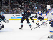 St. Louis Blues left wing Pavel Buchnevich, second from right, gets the pass from center Brayden Schenn (10) before scoring against Seattle Kraken center Alex Wennberg (21) and goaltender Joey Daccord, left, during overtime in an NHL hockey game Friday, Jan. 26, 2024, in Seattle.