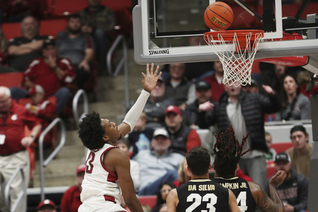 Washington State forward Isaac Jones, left, shoots during the second half of an NCAA college basketball game against Colorado, Saturday, Jan. 27, 2024, in Pullman, Wash. Washington State won 78-69.