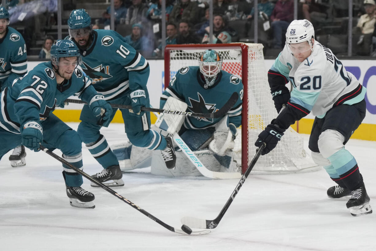 San Jose Sharks left wing William Eklund (72) reaches for the puck against Seattle Kraken right wing Eeli Tolvanen (20) during the second period of an NHL hockey game in San Jose, Calif., Tuesday, Jan. 30, 2024.