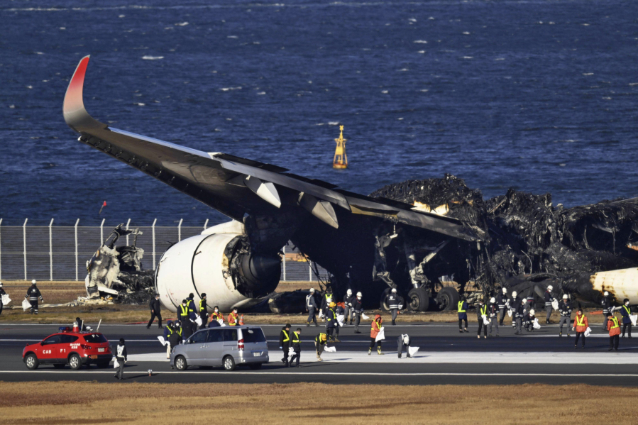 Burnt Japan Airlines plane is seen at Haneda airport on Thursday, Jan. 4, 2024, in Tokyo, Japan. A transcript of communication between traffic control and two aircraft that collided and burst into flames at Tokyo&rsquo;s Haneda Airport showed that only the larger Japan Airlines passenger flight was given permission to use the runway where a coast guard plane was preparing for takeoff.