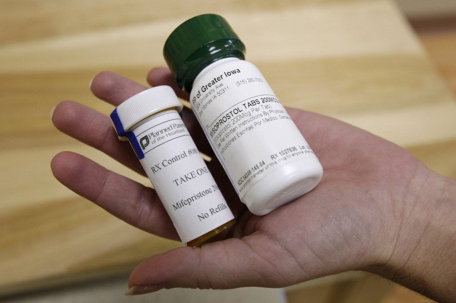 FILE - Bottles of abortion pills mifepristone, left, and misoprostol, right, are shown, Sept. 22, 2010, at a clinic in Des Moines, Iowa. Thousands of women stocked up on abortion pills just in case they needed them, according to new research published Tuesday, Jan. 2, 2024, in JAMA Internal Medicine, with demand peaking in the past couple years at times when it looked like the medications might become harder to get.