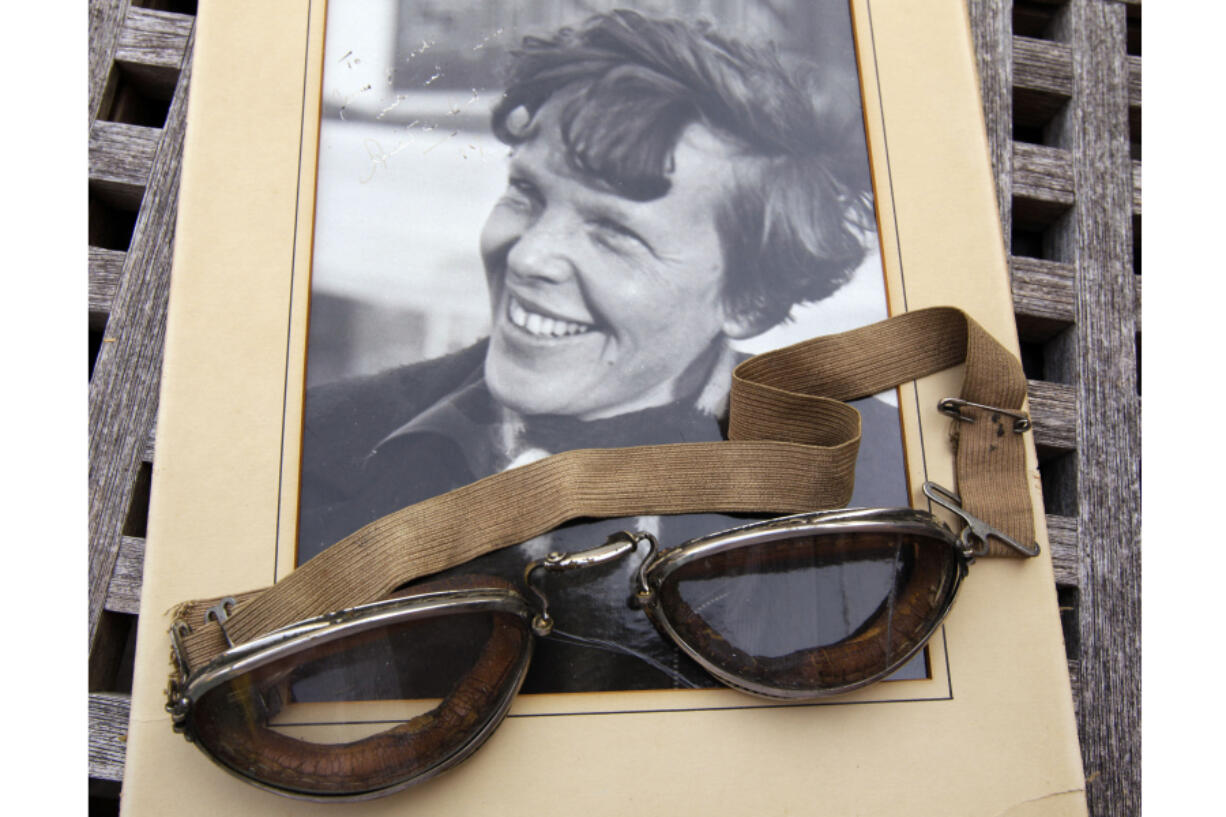 FILE - An original, unpublished personal photo of Amelia Earhart dated 1937, along with goggles she was wearing during her first plane crash are seen Friday, Sept. 9, 2011, at Clars Auction Gallery in Oakland, Calif.