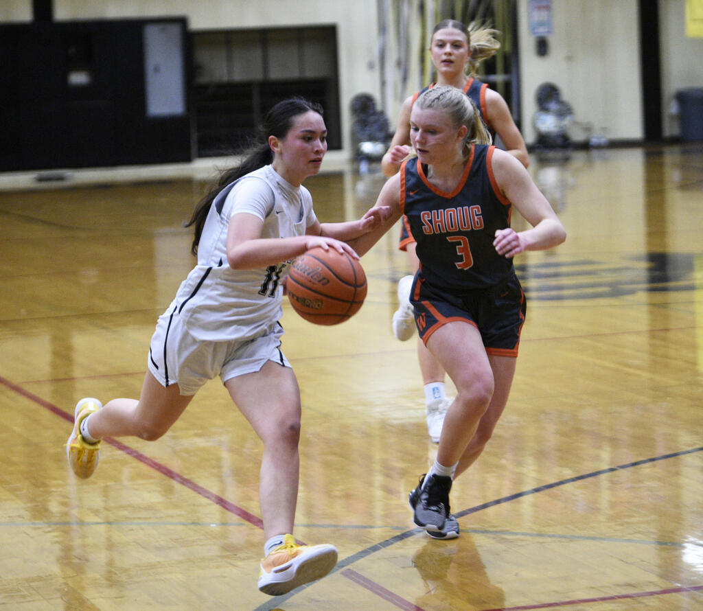 Olivia Carroll of Hudson’s Bay (11) dribbles against Addilyn Gibbons of Washougal (3) during a 2A Greater St. Helens League girls basketball game at Hudson’s Bay High School on Monday, Jan. 29, 2024.