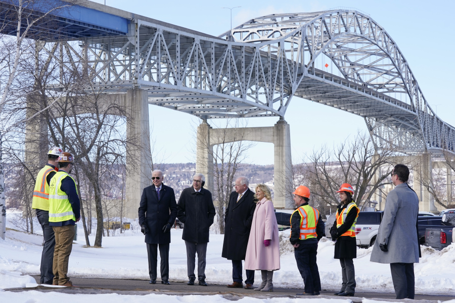 FILE - President Joe Biden and first lady Jill Biden visit the John A. Blatnik Memorial Bridge that connects Duluth, Minn., to Superior, Wis., March 2, 2022, in Superior, Wis.  Biden is returning to the critical swing state of Wisconsin to announce nearly $5 billion in federal funding for upgrading the Blatnik Bridge and for dozens of similar infrastructure projects nationwide.