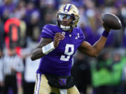 File - Washington quarterback Michael Penix Jr. looks to throw against Washington State during the second half of an NCAA college football game Nov. 25, 2023, in Seattle. The biggest Washington players allowed only 11 sacks this season, paving the way for Penix and No. 2 Huskies to reach the College Football Playoff and earning the Joe Moore Award as the best offensive line in the country.