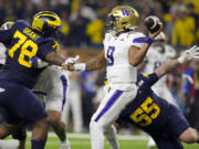 Washington quarterback Michael Penix Jr. passes against Michigan during the first half of the national championship NCAA College Football Playoff game Monday, Jan. 8, 2024, in Houston.
