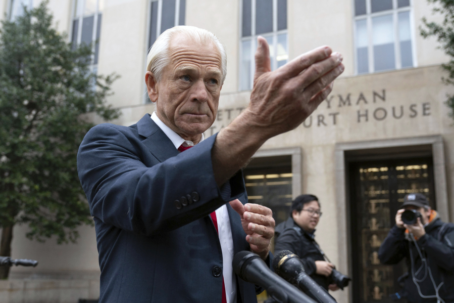 Former Trump White House official Peter Navarro talks to the media as he arrives at U.S. Federal Courthouse in Washington, Thursday, Jan. 25, 2024.