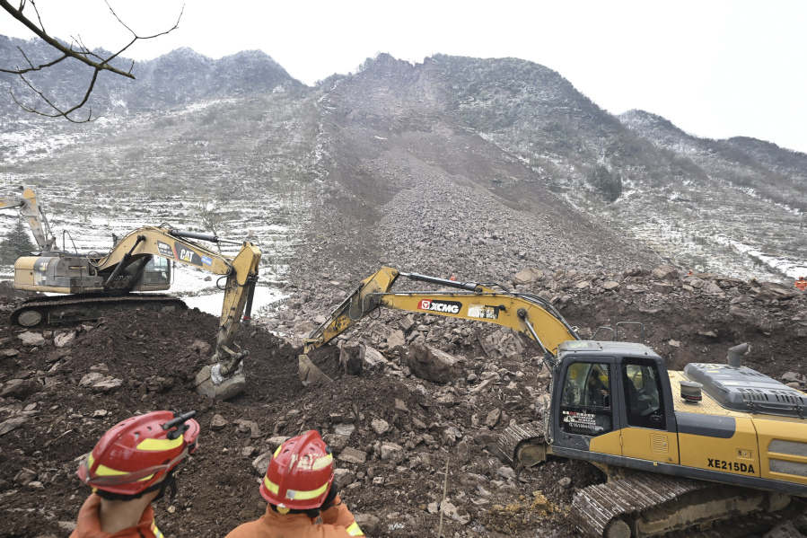 In this photo released by Xinhua News Agency, rescue workers look on as excavators dig at the site of a landslide in Liangshui village, Tangfang Town in the city of Zhaotong in southwestern China&rsquo;s Yunnan Province, Monday Jan. 22, 2024.
