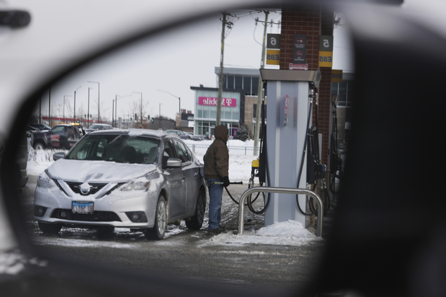 A customer pumps fuel at a gas station in Riverwoods, Ill., Friday, Jan. 19, 2024. On Friday, the Commerce Department issues its December report on consumer spending. (AP Photo/Nam Y.