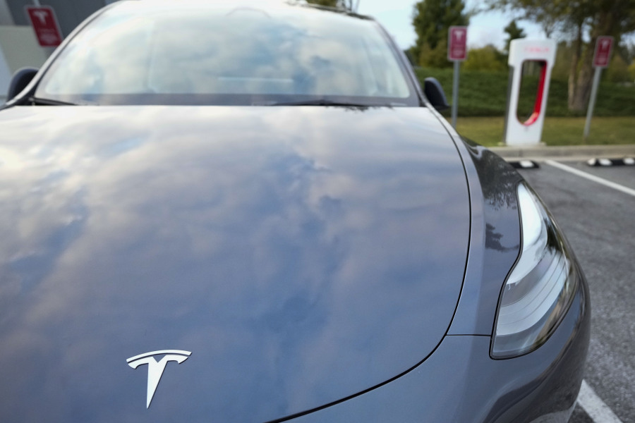 File - A Tesla Model Y Long Range charges, Sept. 27, 2023, in Woodstock, Ga. Government tallies show only 11 of the more than 50 EVs on sale in the U.S. are eligible for tax credits so far this year. Still qualifying for credits are the Tesla Model Y SUV, Chevrolet Bolt compact car and Rivian R1T pickup truck.