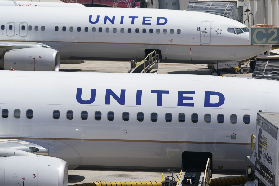 Two United Airlines Boeing 737s are parked at the gate at the Fort Lauderdale-Hollywood International Airport in Fort Lauderdale, Fla., on  July 7, 2022. United Airlines said Monday, Jan. 22, 2024,  it will lose money in the first three months of this year because of the grounding of its Boeing 737 Max 9 planes after a panel blew out of a Max jetliner this month.