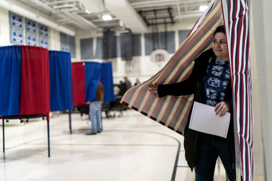 Mary Cullen emerges from a voting booth after filling out her ballot for the New Hampshire presidential primary at a polling site in Manchester, N.H., Tuesday, Jan. 23, 2024.