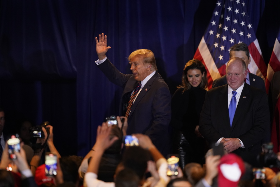 Republican presidential candidate former President Donald Trump waves after speaking at a primary election night party in Nashua, N.H., Tuesday, Jan. 23, 2024.
