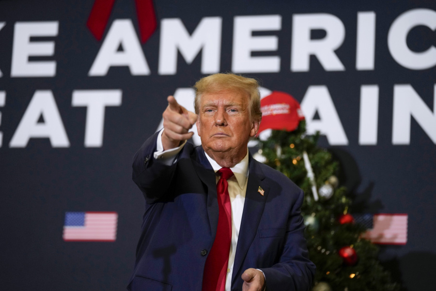 FILE - Former President Donald Trump points to supporters during rally Dec. 19, 2023, in Waterloo, Iowa.