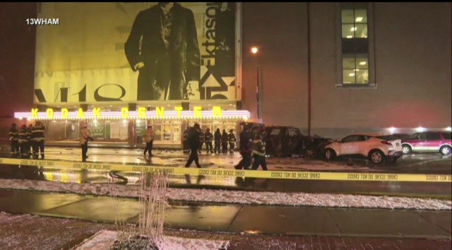 Rochester police investigate a fatal fiery crash outside the Kodak Center in Rochester, N.Y. early Monday, Jan. 1, 2024.  A Ford Expedition struck a Mitsubishi Outlander, sending both vehicles &ldquo;through a group of pedestrians that were in the crosswalk,&rdquo; the statement said.