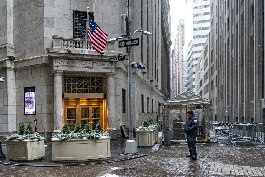 A security officer stands outside an entrance to the New York Stock Exchange on Friday, Jan. 19, 2024, in New York. Wall Street is rising Friday and may break past its all-time high set two years ago, before the highest inflation and interest rates in decades sent financial markets tanking worldwide.  (AP Photo/Peter K.