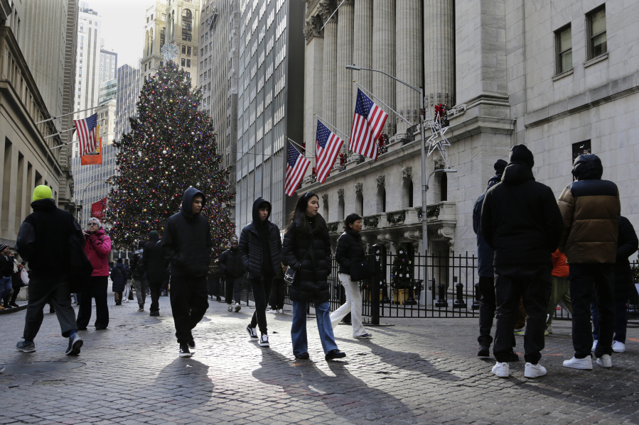 Pedestrians pass the New York Stock Exchange on Tuesday, Jan. 2, 2024 in New York. The S&amp;P 500 was lower in midday trading after pulling to the brink of its all-time high set roughly two years ago.