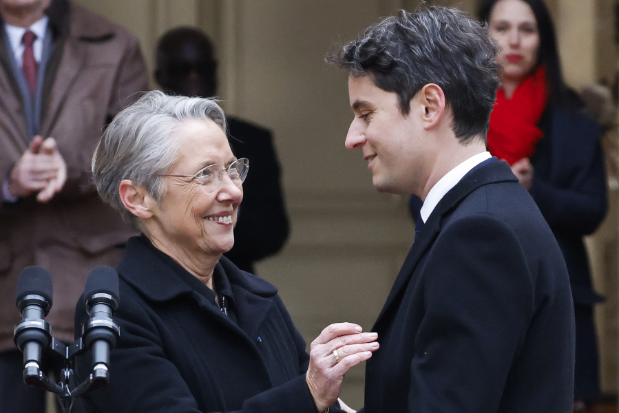 New French prime minister Gabriel Attal, right, smiles to outgoing prime minister Elisabeth Borne after the handover ceremony, Tuesday, Jan. 9, 2024 in Paris. Gabriel Attal was named as France&rsquo;s youngest-ever prime minister, as President Emmanuel Macron seeks a fresh start for the rest of his term amid growing political pressure from the far right.