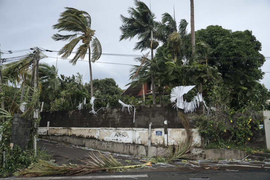 Fallen branches and damage is seen Monday in La Plaine Saint-Paul on the French Indian Ocean island of Reunion.