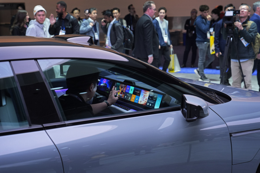 People sit in a Sony Honda Mobility Afeela EV at the Sony booth during the CES tech show Tuesday, Jan. 9, 2024, in Las Vegas.