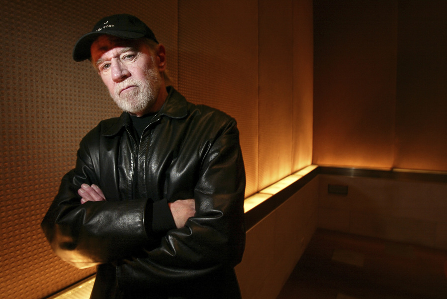 FILE - Actor and comedian George Carlin poses in a New York hotel March 19, 2004. Carlin&rsquo;s estate has filed a lawsuit against the media company behind a fake hourlong comedy special that purportedly uses artificial intelligence to recreate the late standup comic&rsquo;s style and material. The lawsuit filed in federal court in Los Angeles on Thursday, Jan. 25, 2024, asks that a judge order the podcast outlet, Dudesy, to immediately take down the audio special, &ldquo;George Carlin: I&rsquo;m Glad I&rsquo;m Dead,&rdquo; in which a synthesis of Carlin, who died in 2008, delivers commentary on current events.