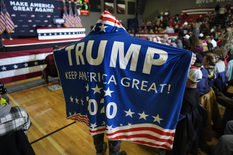 Supporters wait for former President Donald Trump to arrive at a commit to caucus rally, Saturday, Jan. 6, 2024, in Clinton, Iowa.