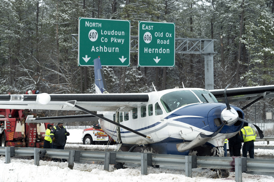 Southern Airways Express Flight 246 sits on the Loudoun County Parkway on Friday in Dulles, Va., after an emergency landing near Washington Dulles International Airport.