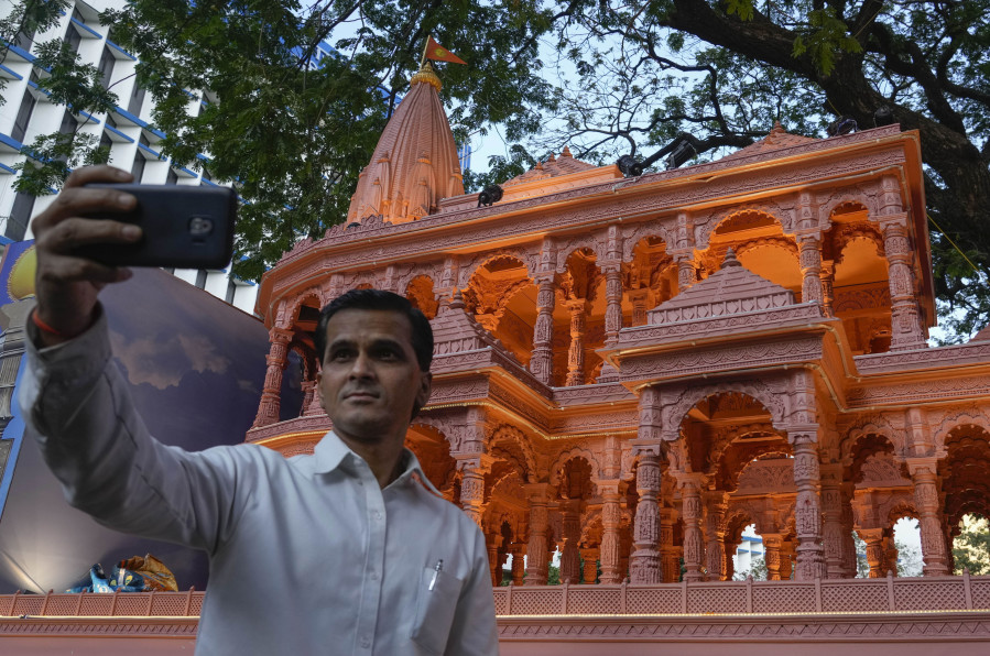 A person takes selfie in front of a replica of the Lord Ram temple in Ayodhya, which is on display outside India&rsquo;s ruling Bharatiya Janata Party office, in Mumbai, India, Tuesday, Jan. 16, 2024.