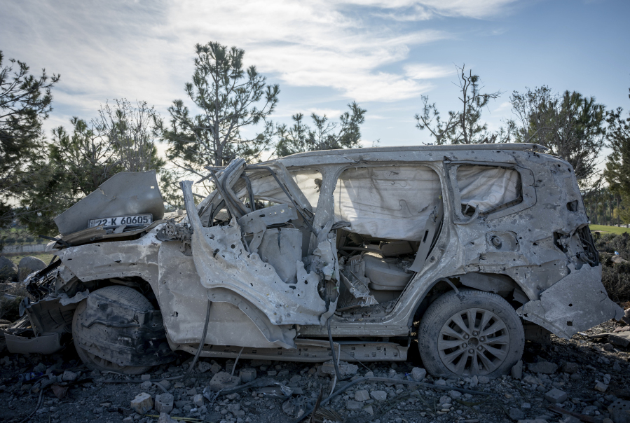 A destroyed car is seen by the house of Peshraw Dizayi that was hit in Iranian missile strikes in Irbil, Iraq, Tuesday, Jan. 16, 2024. Dizayi, a prominent local businessman, was killed in one of the Irbil strikes along with members of his family.