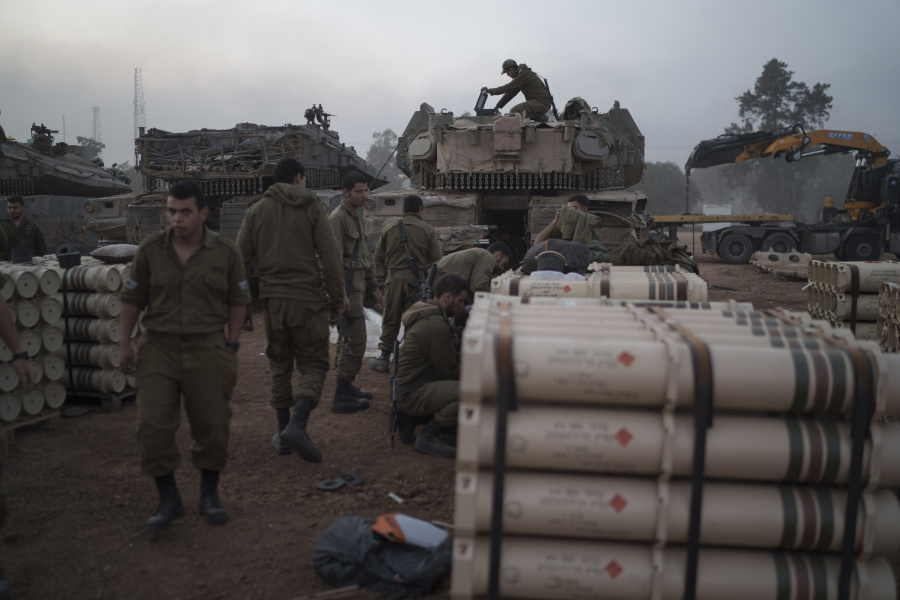 Israeli soldiers from the artillery unit store tank shells in a staging area at the Israeli-Gaza border in southern Israel, Monday, Jan. 1, 2024. The army is battling Palestinian militants across Gaza in the war ignited by Hamas&rsquo; Oct. 7 attack into Israel.