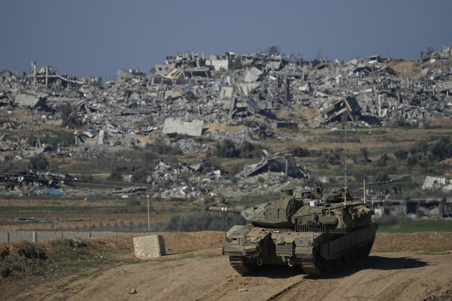 Israeli soldiers take up positions near the Gaza Strip border, in southern Israel, Sunday, Jan.7, 2024.