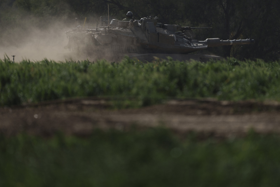Israeli soldiers move on the top of a tank near the Israeli-Gaza border, as seen from southern Israel, Tuesday, Jan. 23, 2024.