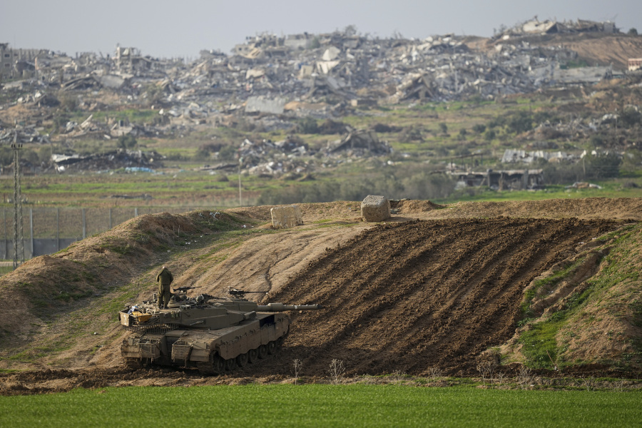 Israeli soldiers take up position along the Israeli-Gaza border, in southern Israel, Wednesday, Jan.