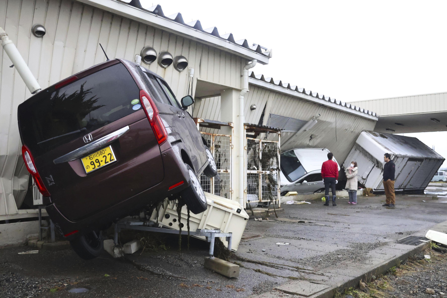The cars are seen damaged as the city was hit by the earthquakes and tsunami in Suzu, Ishikawa prefecture, Japan Wednesday, Jan. 3, 2024.