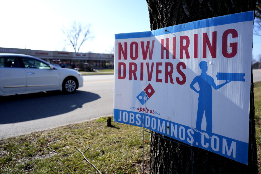 A hiring sign is posted outside of a Domino&#039;s restaurant in Wheeling, Ill., Monday, Jan. 29, 2024. On Tuesday, the Labor Department reports on job openings and labor turnover for December. (AP Photo/Nam Y.