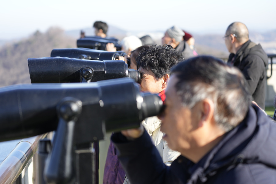 Visitors use binoculars to see the North Korean side from the unification observatory, in Paju, South Korea, Tuesday, Jan. 16, 2024. North Korean leader Kim Jong Un said his country would no longer pursue reconciliation with South Korea and called for rewriting the North&rsquo;s constitution to eliminate the idea of shared statehood between the war-divided countries, state media said Tuesday.