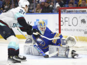 Seattle Kraken center Alex Wennberg (21) puts the puck past Buffalo Sabres goaltender Devon Levi (27) for a goal during the second period of an NHL hockey game Tuesday, Jan. 9, 2024, in Buffalo, N.Y. (AP Photo/Jeffrey T.