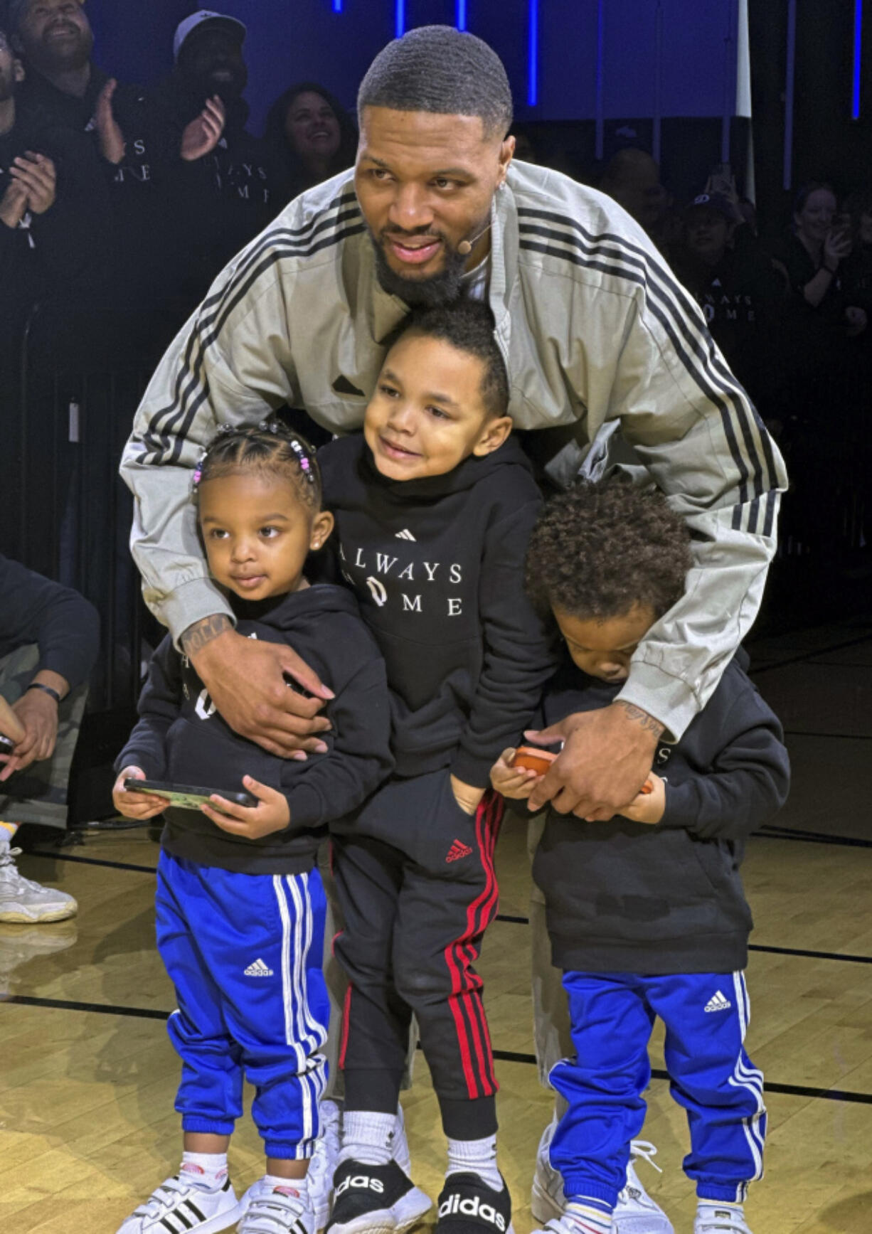 Milwaukee Bucks point guard Damian Lillard poses with his children at an event on Tuesday,  Jan. 30, 2024 in Portland, Ore. Lillard was playing in Portland for the first time since he was traded from the Trail Blazers to the Bucks in the offseason. (AP Photo/Anne M.