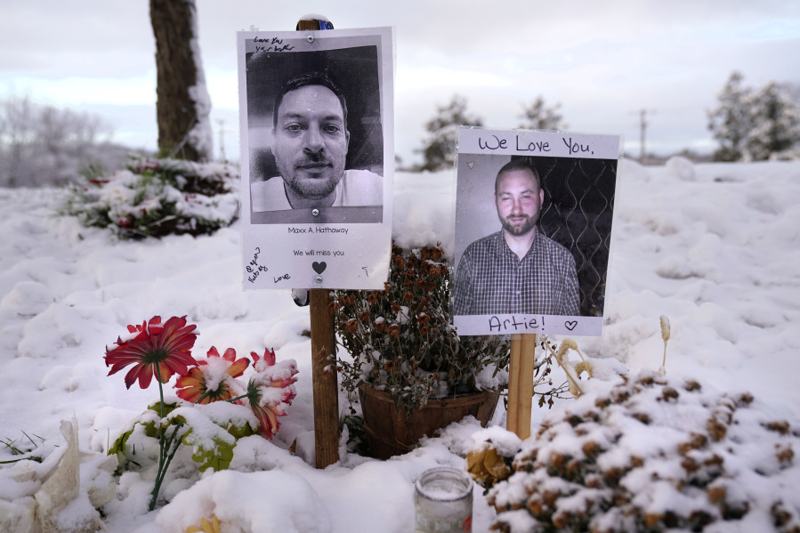FILE - Pictures of two of the victims of the October 2023 mass shooting by Army reservist Robert Card are seen at a makeshift memorial in Lewiston, Maine, Dec. 5, 2023. Despite the warning by Card&rsquo;s friend and fellow Army reservist Sean Hodgson, which came alongside a series of other glaring red flags, Army officials discounted the warnings and ultimately did not stop Card from committing Maine&rsquo;s deadliest mass shooting when he killed multiple people in Lewiston. (AP Photo/Robert F.
