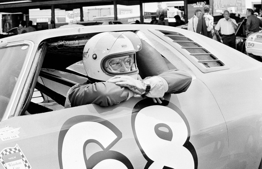 FILE - Between practice runs for the World 600, Janet Guthrie leans out of the window of the stock car racer in Charlotte, N.C., May 29, 1976. Guthrie will be inducted into the NASCAR Hall of Fame on Friday night, Jan.