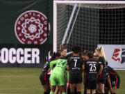 FILE -  Portland Thorns FC players huddle up prior to the first half of an NWSL Challenge Cup soccer match against Kansas City Friday, April 9, 2021, in Portland, Ore. The Portland Thorns have been acquired by the Bhathal family, investors in the NBA&rsquo;s Sacramento Kings, the National Women&rsquo;s Soccer League team announced Wednesday, Jan. 3, 2024.