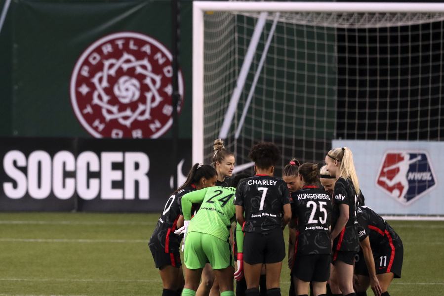 FILE -  Portland Thorns FC players huddle up prior to the first half of an NWSL Challenge Cup soccer match against Kansas City Friday, April 9, 2021, in Portland, Ore. The Portland Thorns have been acquired by the Bhathal family, investors in the NBA&rsquo;s Sacramento Kings, the National Women&rsquo;s Soccer League team announced Wednesday, Jan. 3, 2024.