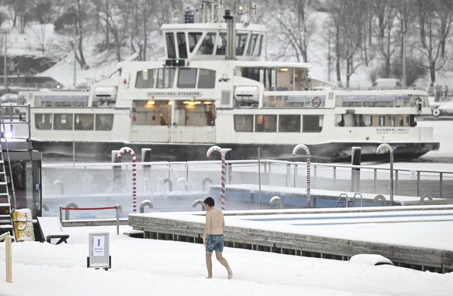 A man walks by the Allas Sea Pool, in Southern Helsinki, Finland, Tuesday, Jan. 2, 2024. Finland and Sweden have recorded this winter&rsquo;s cold records on Tuesday as a temperatures plummeted to over minus 40 degrees as a result of a cold spell prevailing in the Nordic region.