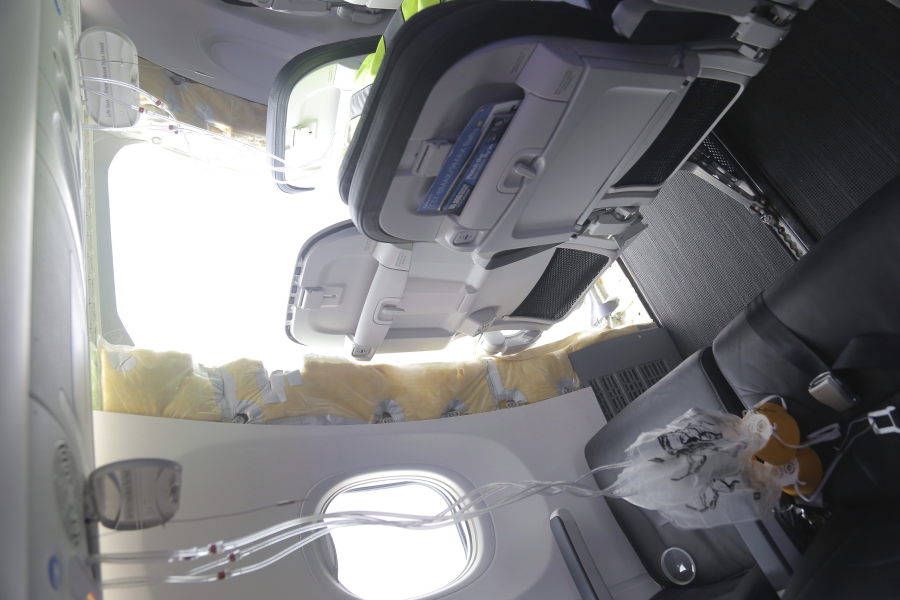 This photo released by the National Transportation Safety Board shows a gaping hole where the paneled-over door had been at the fuselage plug area of Alaska Airlines Flight 1282 on Sunday, Jan. 7, 2024, in Portland, Ore. A panel used to plug an area reserved for an exit door on the Boeing 737 Max 9 jetliner blew out Jan. 5, shortly after the flight took off from Portland, forcing the plane to return to Portland International Airport.