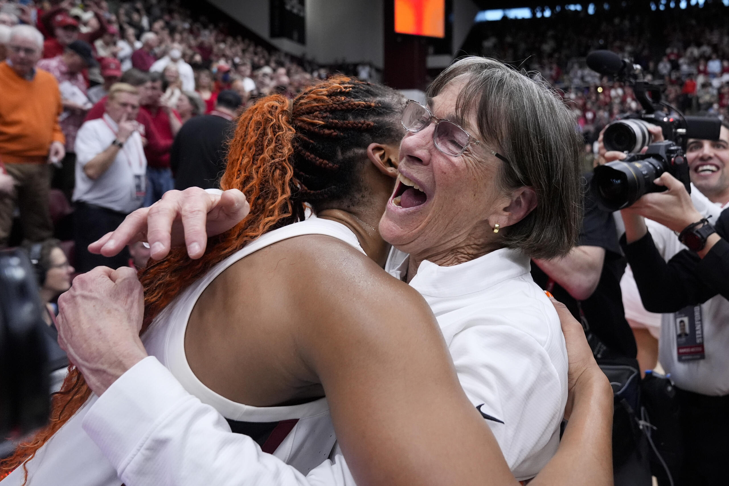 Stanford head coach Tara VanDerveer, right, is congratulated by forward Kiki Iriafen after the team's victory over Oregon State in an NCAA college basketball game, Sunday, Jan. 21, 2024, in Stanford, Calif. VanDerveer broke the college basketball record for wins with the victory. (AP Photo/Godofredo A.