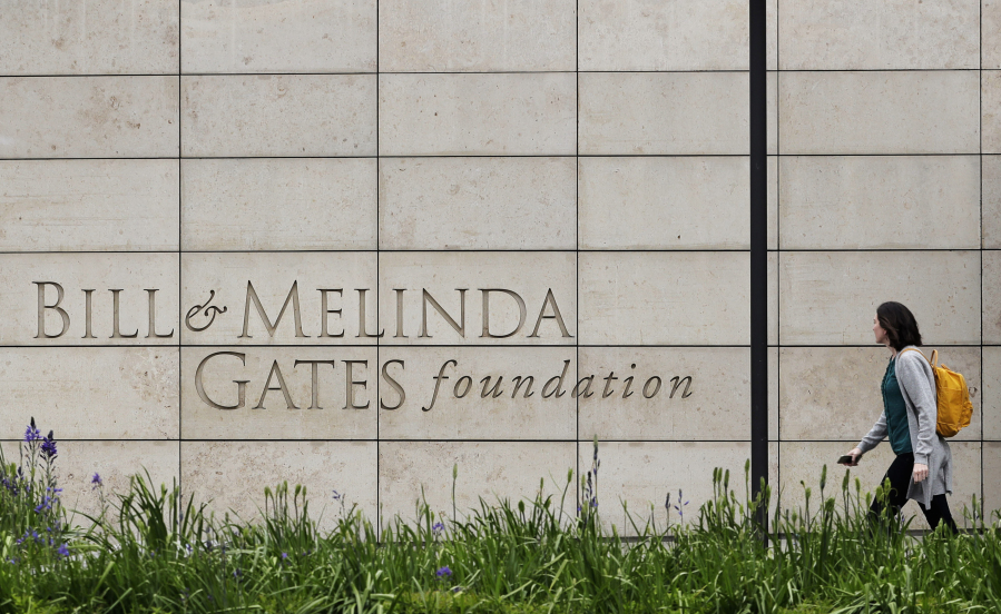 FILE - A person walks by the headquarters of the Bill and Melinda Gates Foundation on April 27, 2018, in Seattle. The CEO of the Bill &amp; Melinda Gates Foundation, Mark Suzman, called on billionaires to give away more of their money to address inequality and to do it soon in an annual letter released Thursday, Jan. 25, 2024. (AP Photo/Ted S.