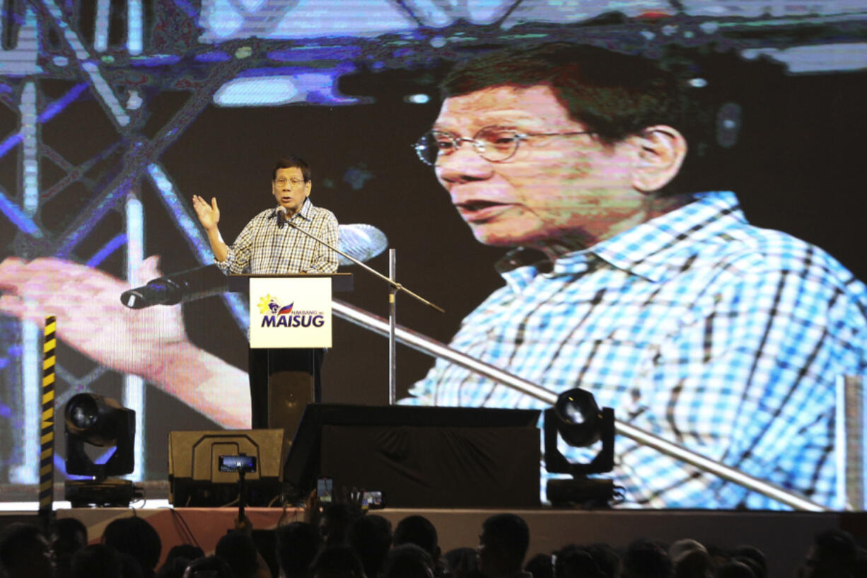 Former Philippine President Rodrigo Duterte gestures during his speech in Davao, southern Philippines late Sunday Jan. 28, 2024.