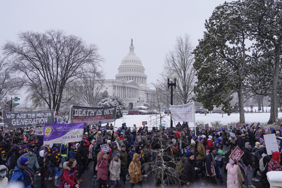 Anti-abortion activists march during the annual March for Life in front of the Supreme Court on Friday, Jan. 19, 2024, in Washington, with the Capitol in the background.