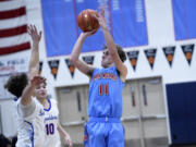 Braydon Olson of Mark Morris (11) takes a shot against Ridgefield in a 2A Greater St. Helens League boys basketball game at Mark Morris High School on Saturday, January 20, 2024.